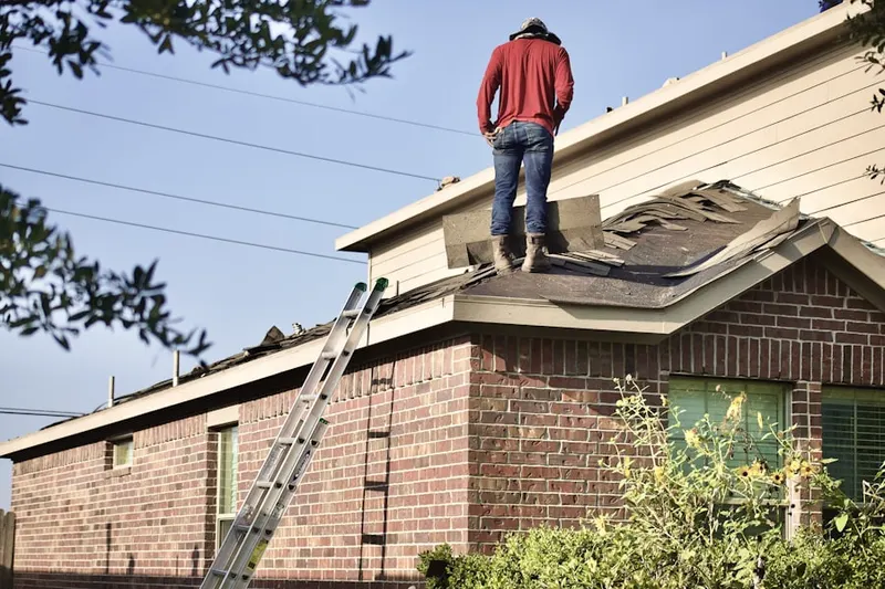 Professional roofer working on a residential roof in Galion
